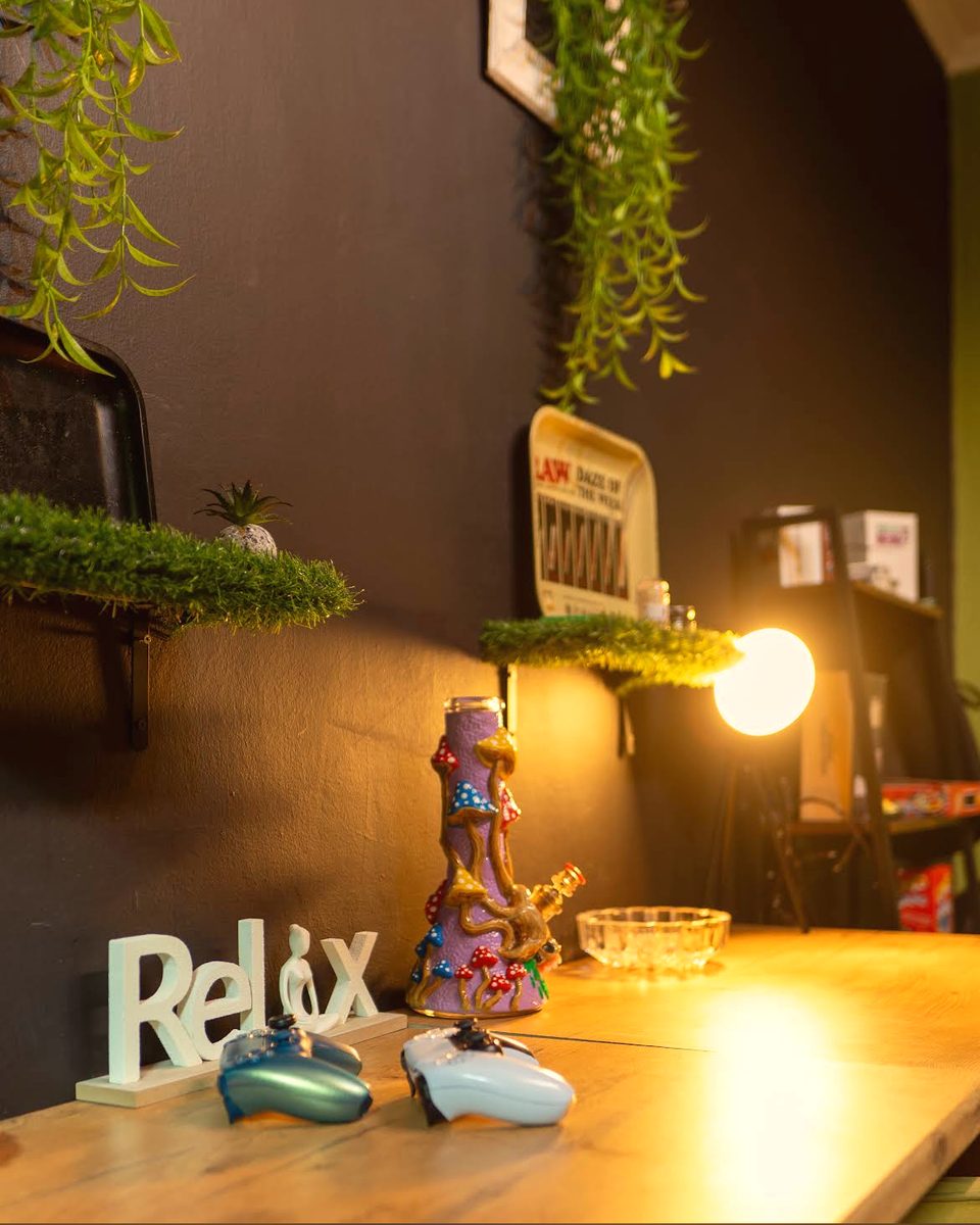 The darker social room, warm lamplight on the counter
